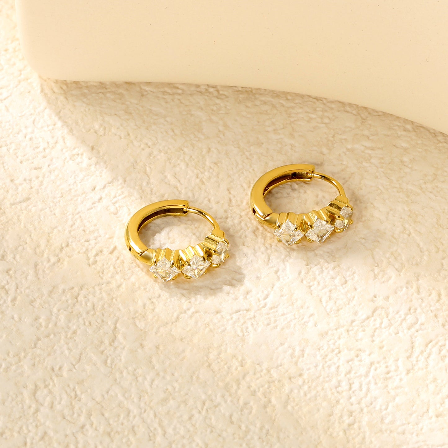Wholesale Stainless Steel Contemporary Triple Square Zircon Hoop EarringsClose-ups of the gold plating and details