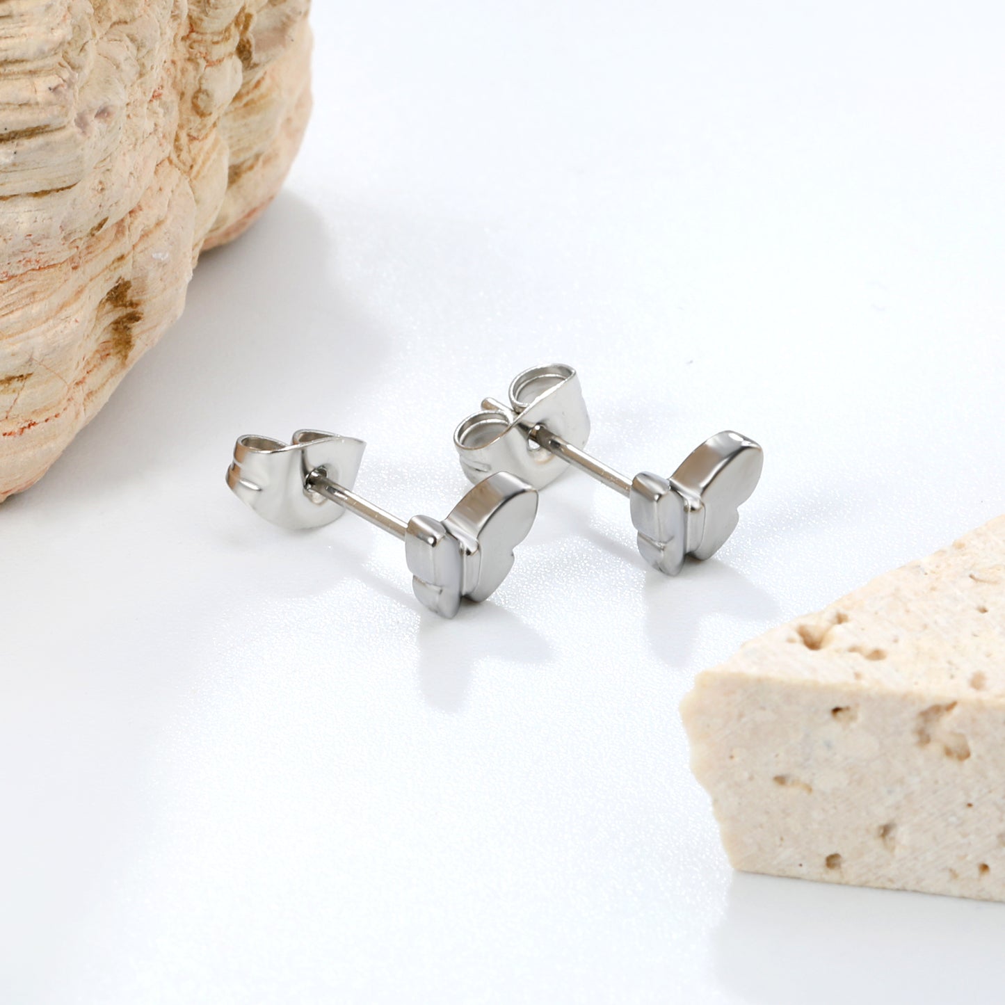 Wholesale stainless steel 18K gold plated butterfly regular pin earringsClose-up of the light-colored ambiance_silver