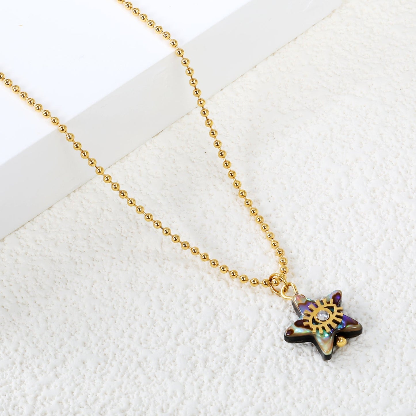 Embrace Coastal Mystique with an Iridescent Abalone Shell Star Eye Chain