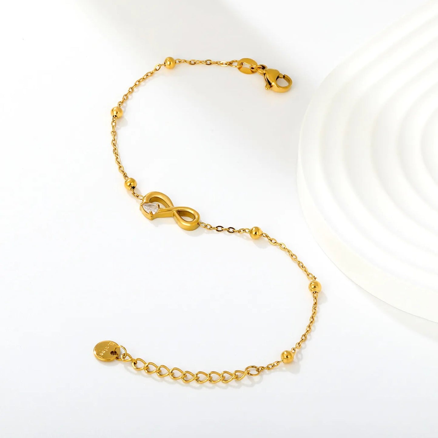 A Modern Twist on Classic Infinity Jewelry Featuring a Solitaire Drop Stone