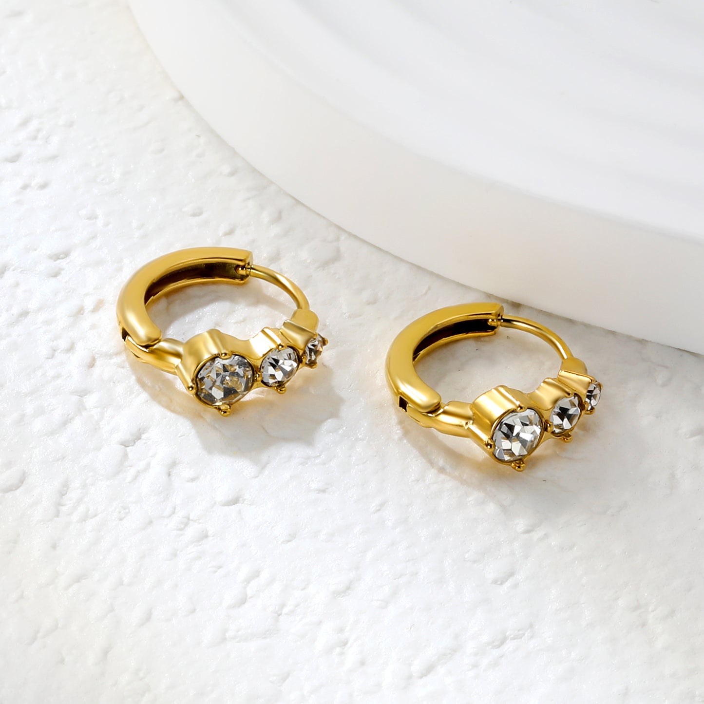 Bulk 18K Gold Plated Asymmetrical Round Zircon Hoop EarringsClose-up of the light-colored ambiance