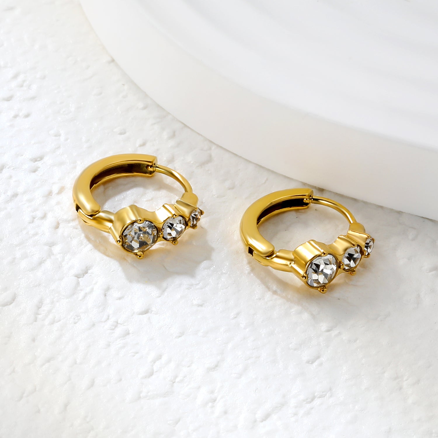 Bulk 18K Gold Plated Asymmetrical Round Zircon Hoop EarringsClose-up of the light-colored ambiance