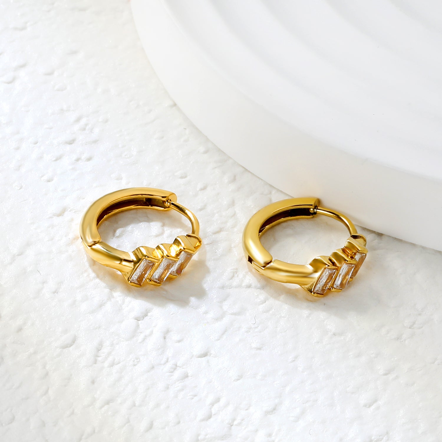 Bulk 18K Gold Plated Asymmetrical Square Zircon Hoop EarringsClose-up of the light-colored ambiance