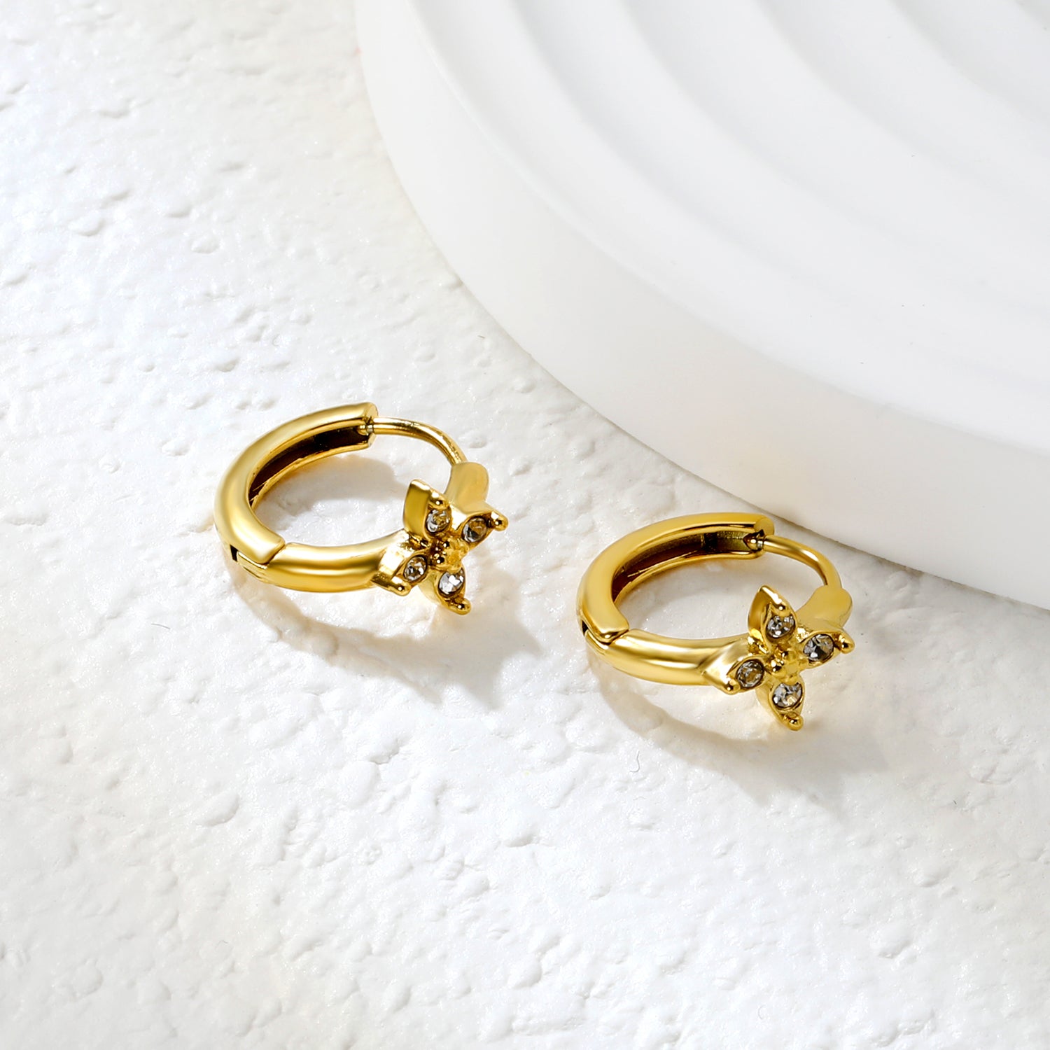 Bulk 18K Gold Plated Botanical Cross-Flower Zircon Hoop EarringsClose-up of the light-colored ambiance