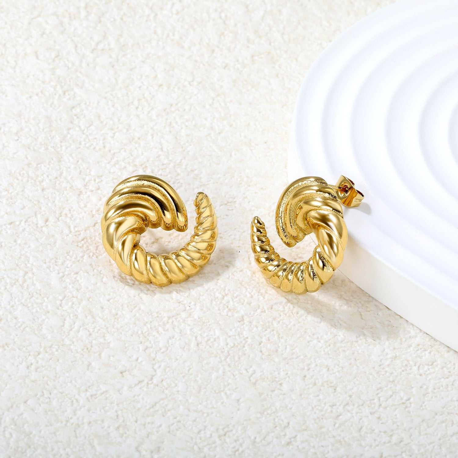 Bulk 18K Gold Plated Celestial Spiral Horn Stud EarringsClose-up of the light-colored ambiance