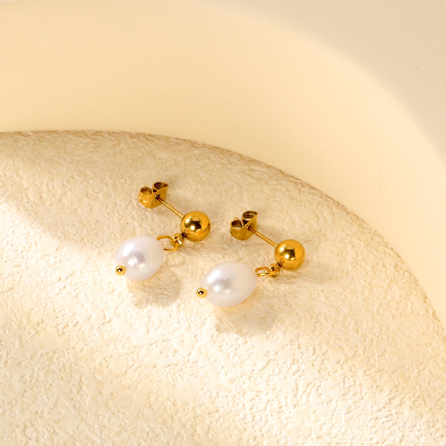 Bulk 18K Gold Plated Classic Pearl & Bead Drop StudsClose-up of the light-colored ambiance