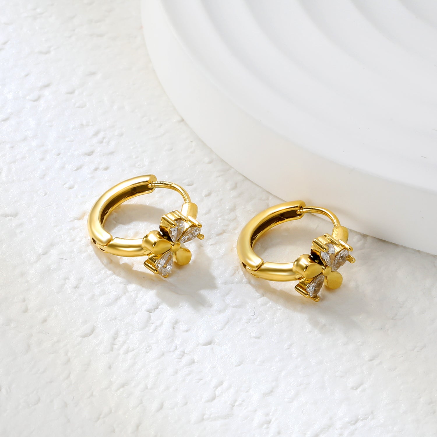 Bulk 18K Gold Plated Delicate Triple Stone Flower Hoop EarringsClose-up of the light-colored ambiance