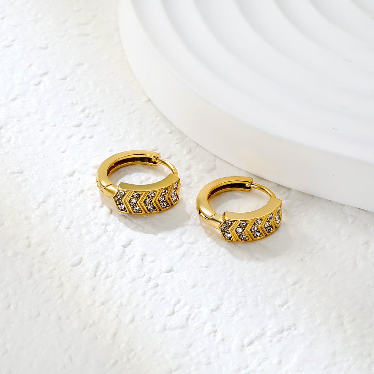 Bulk 18K Gold Plated Geometric Hexagon Crystal Hoop EarringsClose-up of the light-colored ambiance