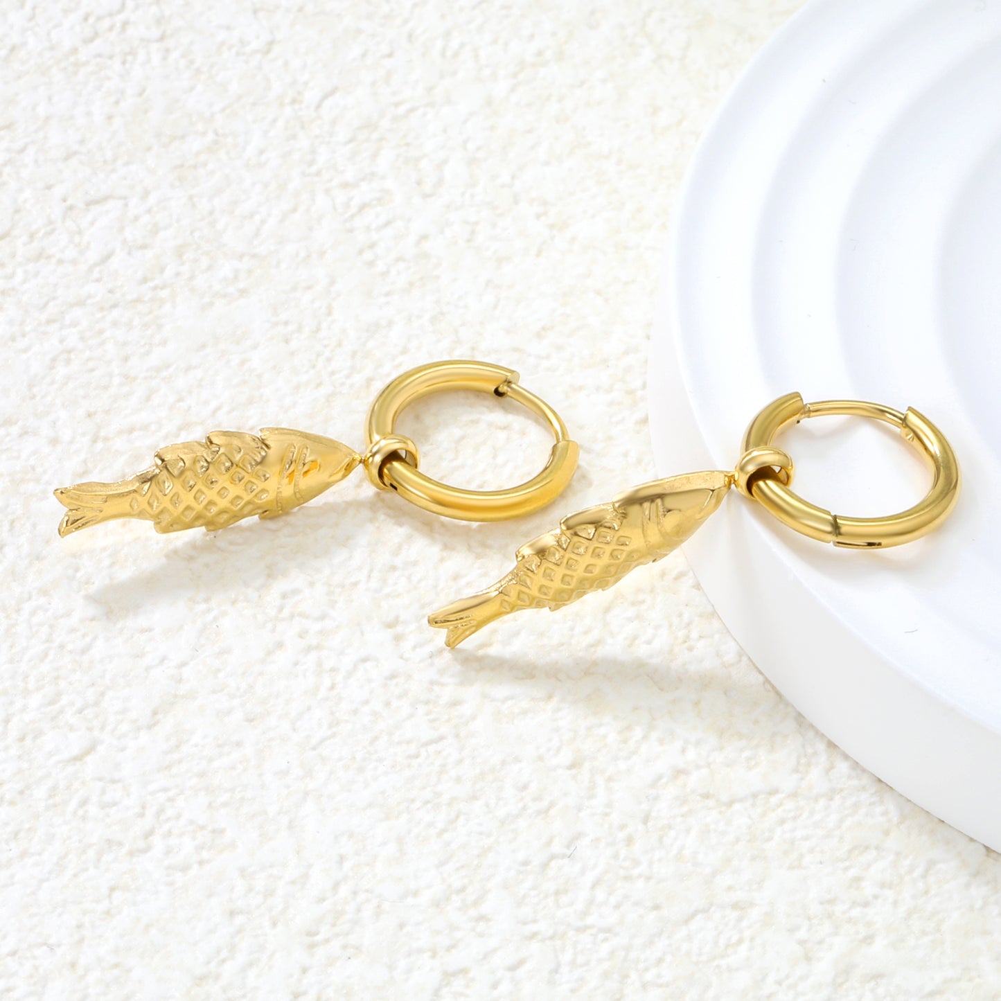Bulk 18K Gold Plated Luxe Fish Charm Hoop EarringsClose-up of the light-colored ambiance