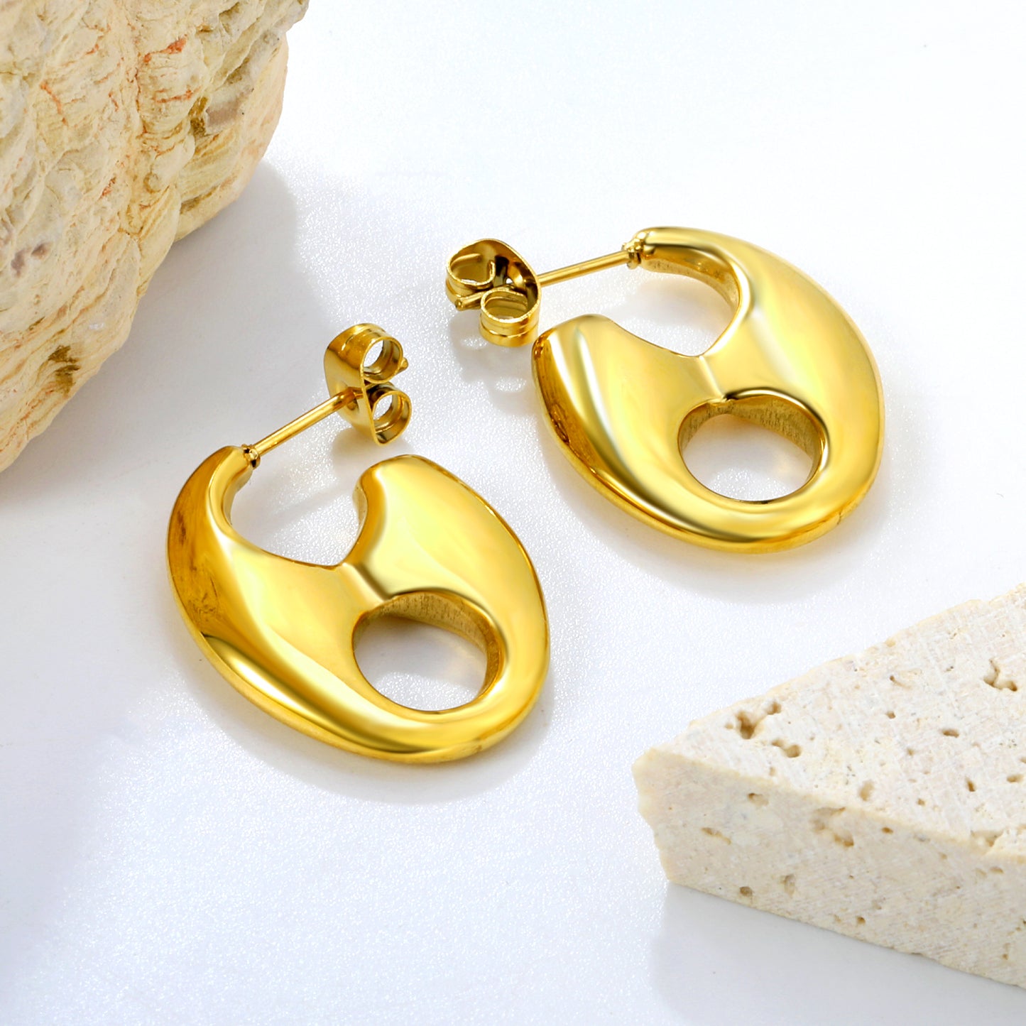 Bulk 18K Gold Plated Modern Pig Nose Open Stud EarringsClose-up of the light-colored ambiance