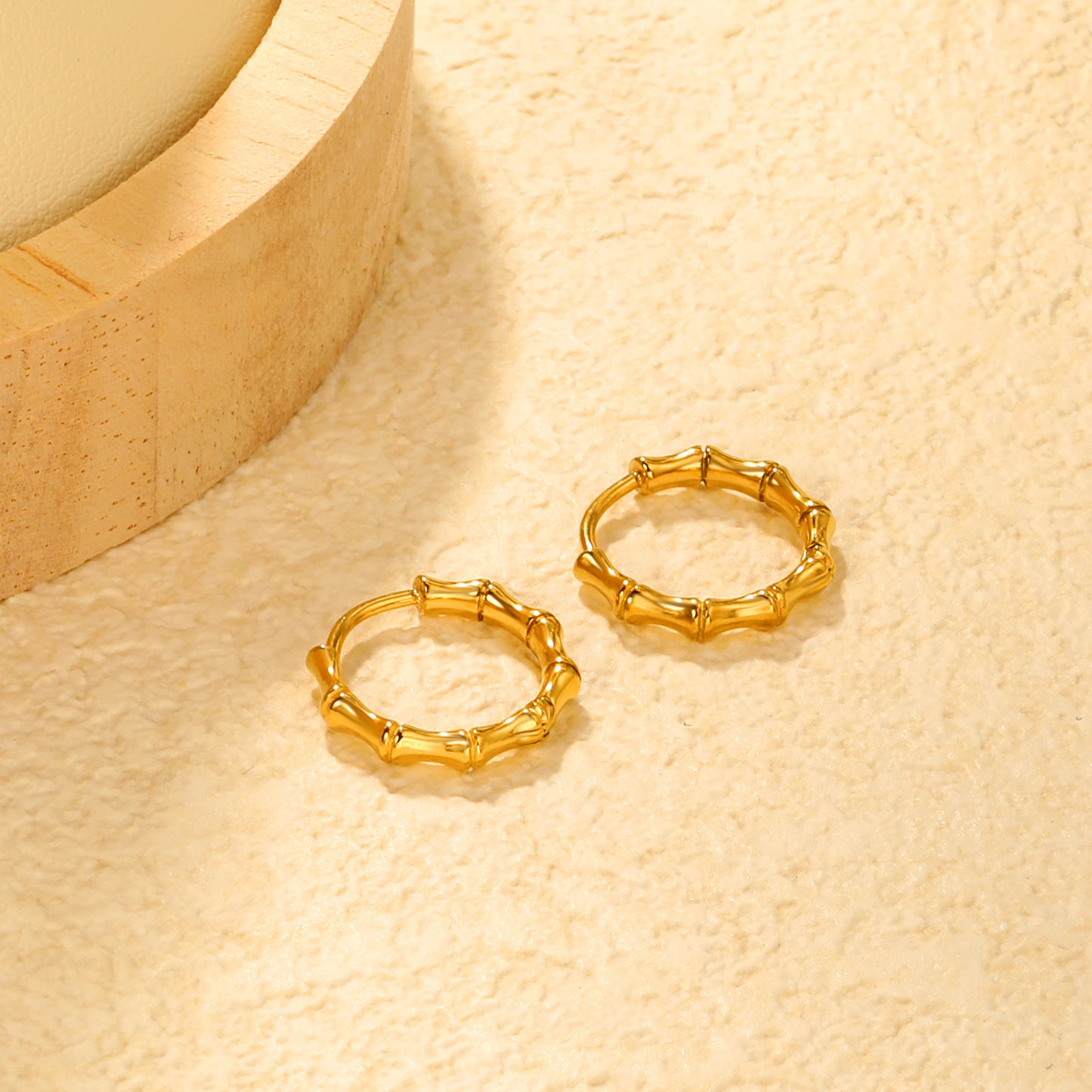 Bulk 18K Gold Plated Sleek Polished Bamboo EarringsClose-up of the light-colored ambiance
