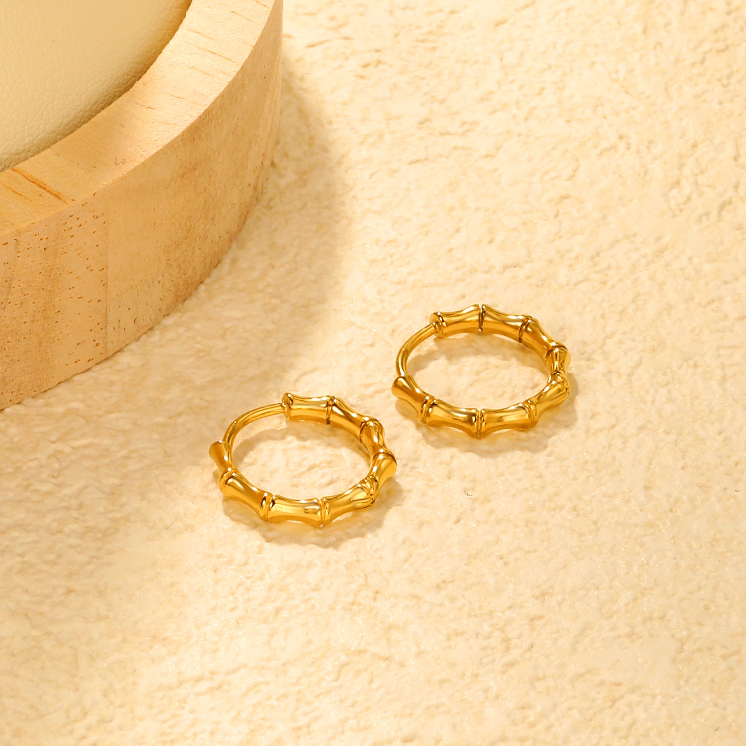 Bulk 18K Gold Plated Sleek Polished Bamboo EarringsClose-up of the light-colored ambiance