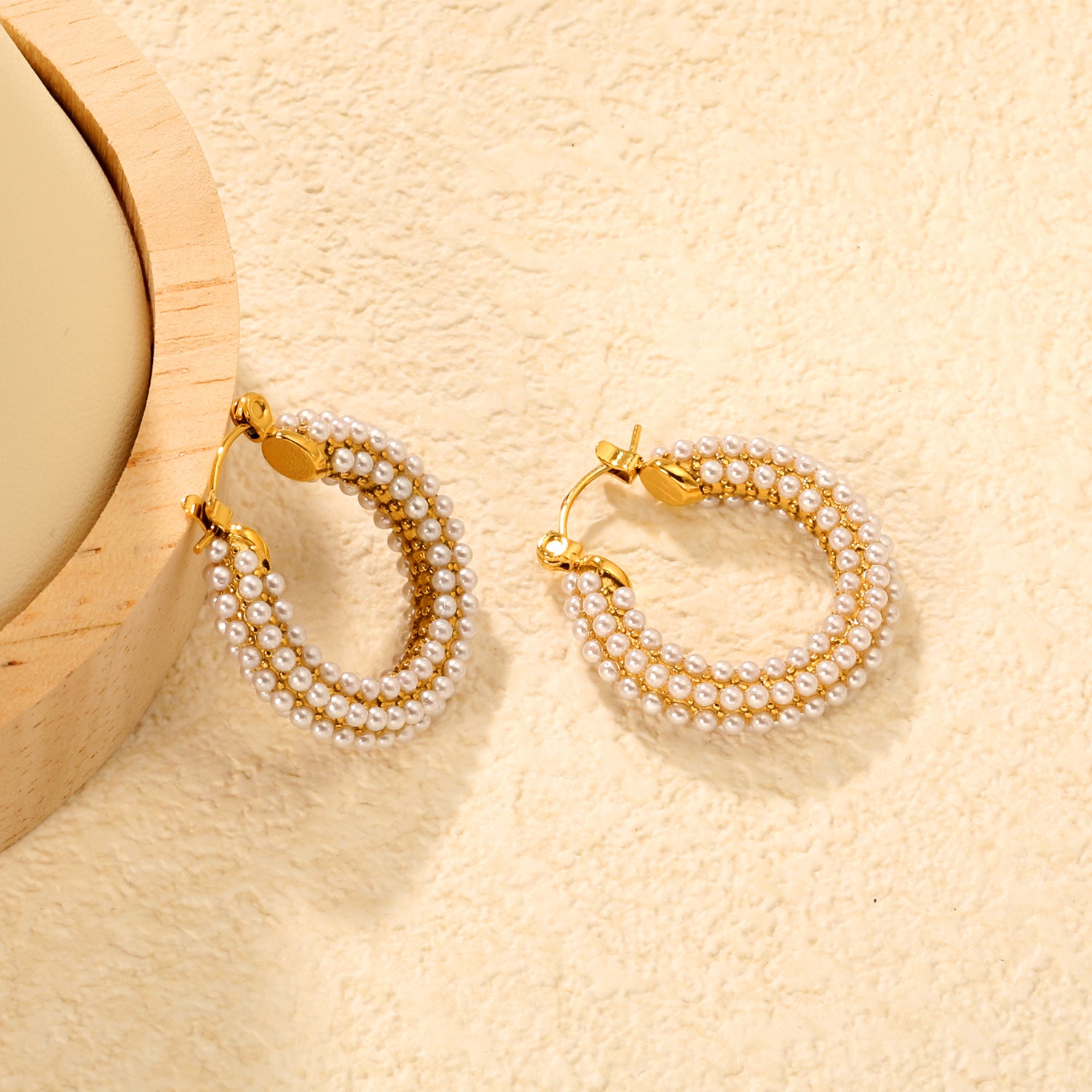 Bulk Buy 18K Gold Plated Pearl Hoop Earrings Double Row Waterproof DesignClose-up of the light-colored ambiance