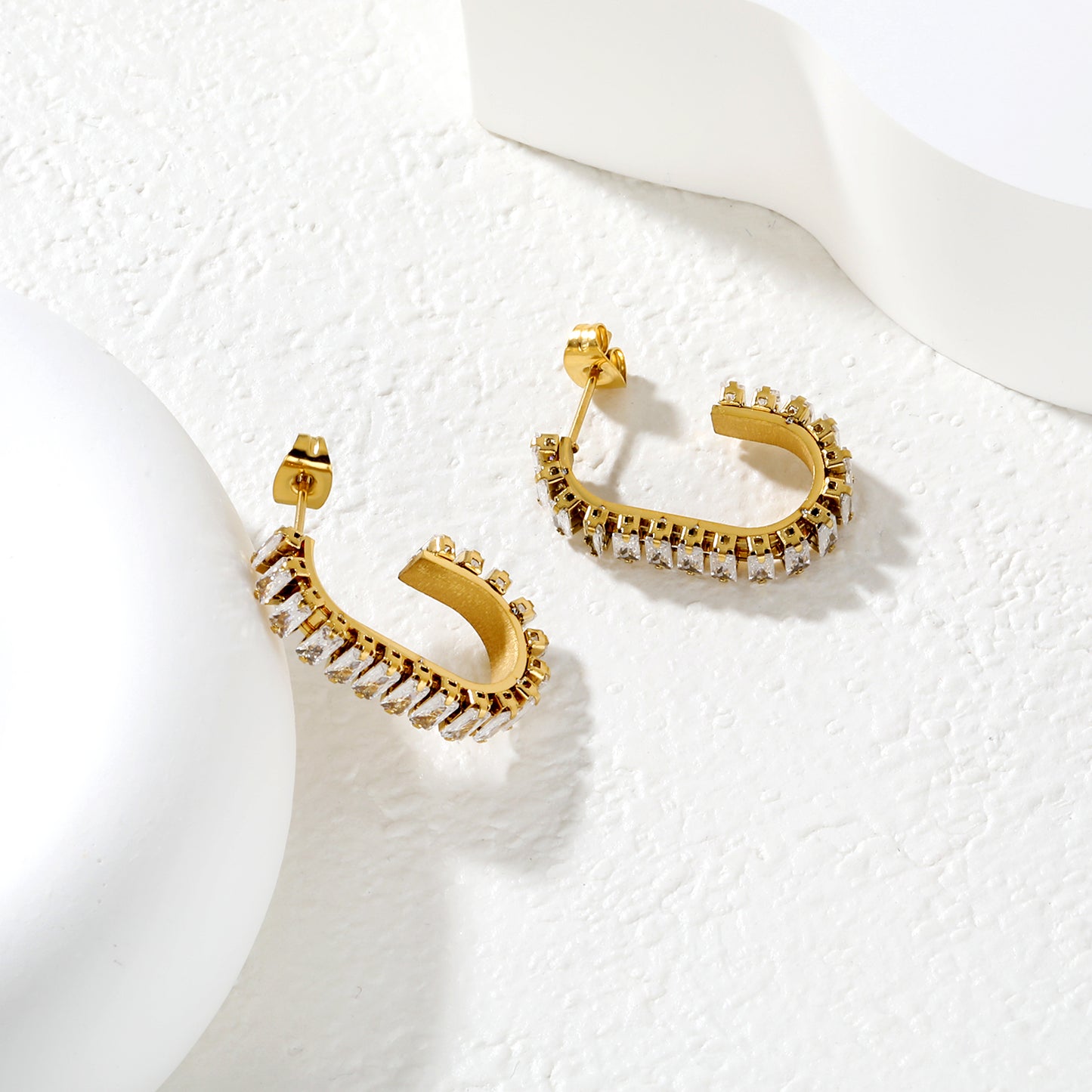 Bulk Waterproof 18K PVD Gold Plated Inside Out Pave C HoopsClose-up of the light-colored ambiance