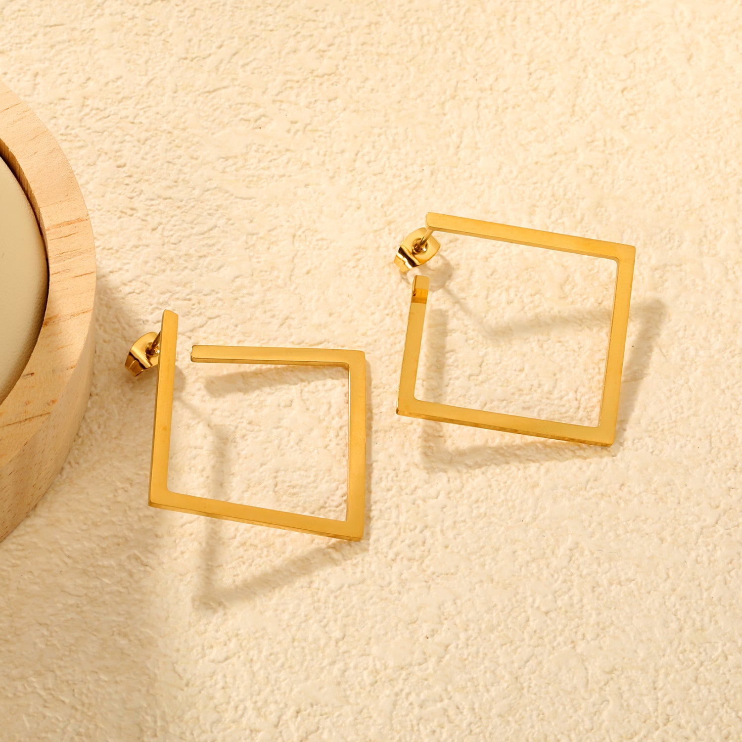 Bulk Waterproof PVD Gold Plated Minimalist Square Frame StudsClose-up of the light-colored ambiance