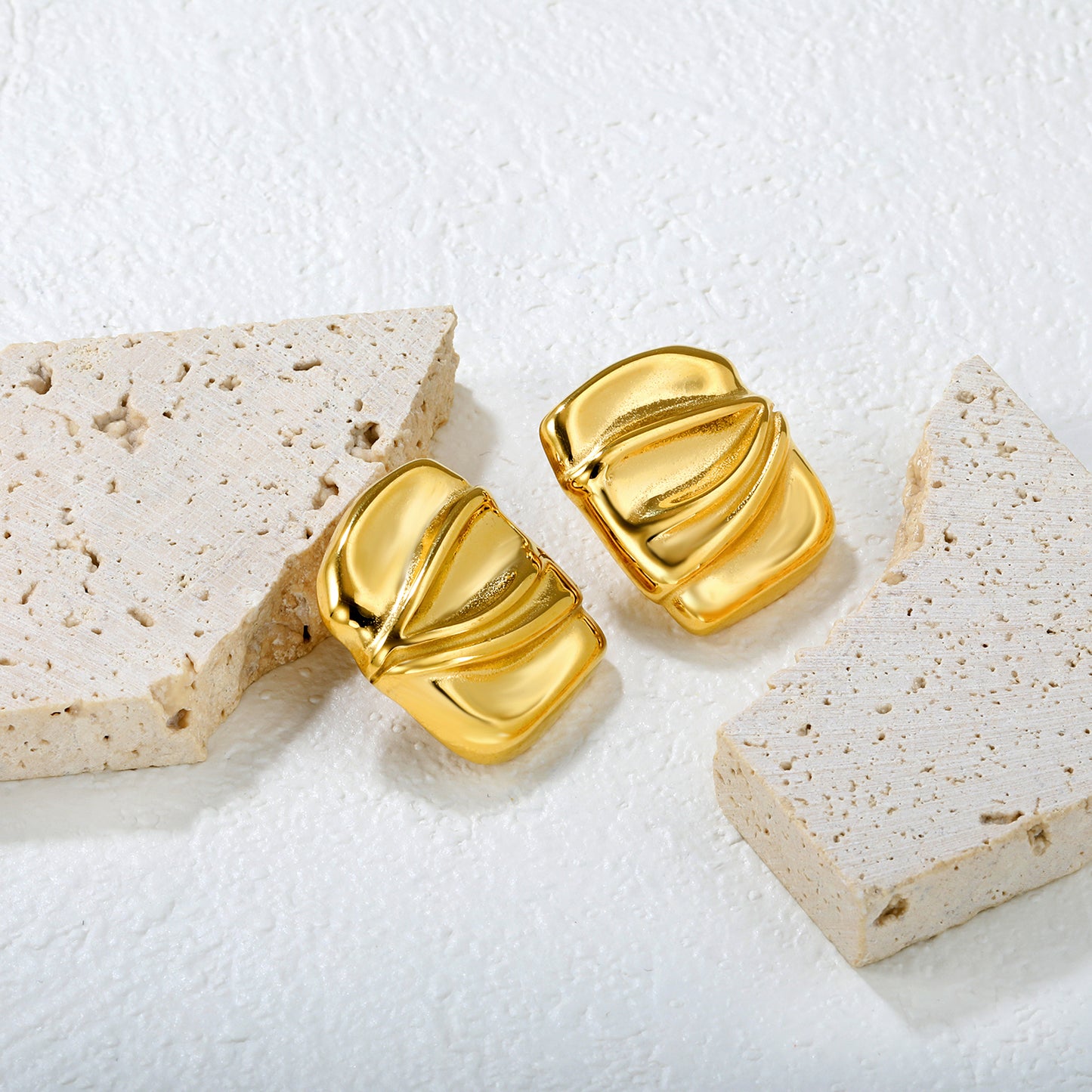 Wholesale 18K Gold Plated Crushed Metal Earrings Textured Surface Industrial ArtClose-up of the light-colored ambiance