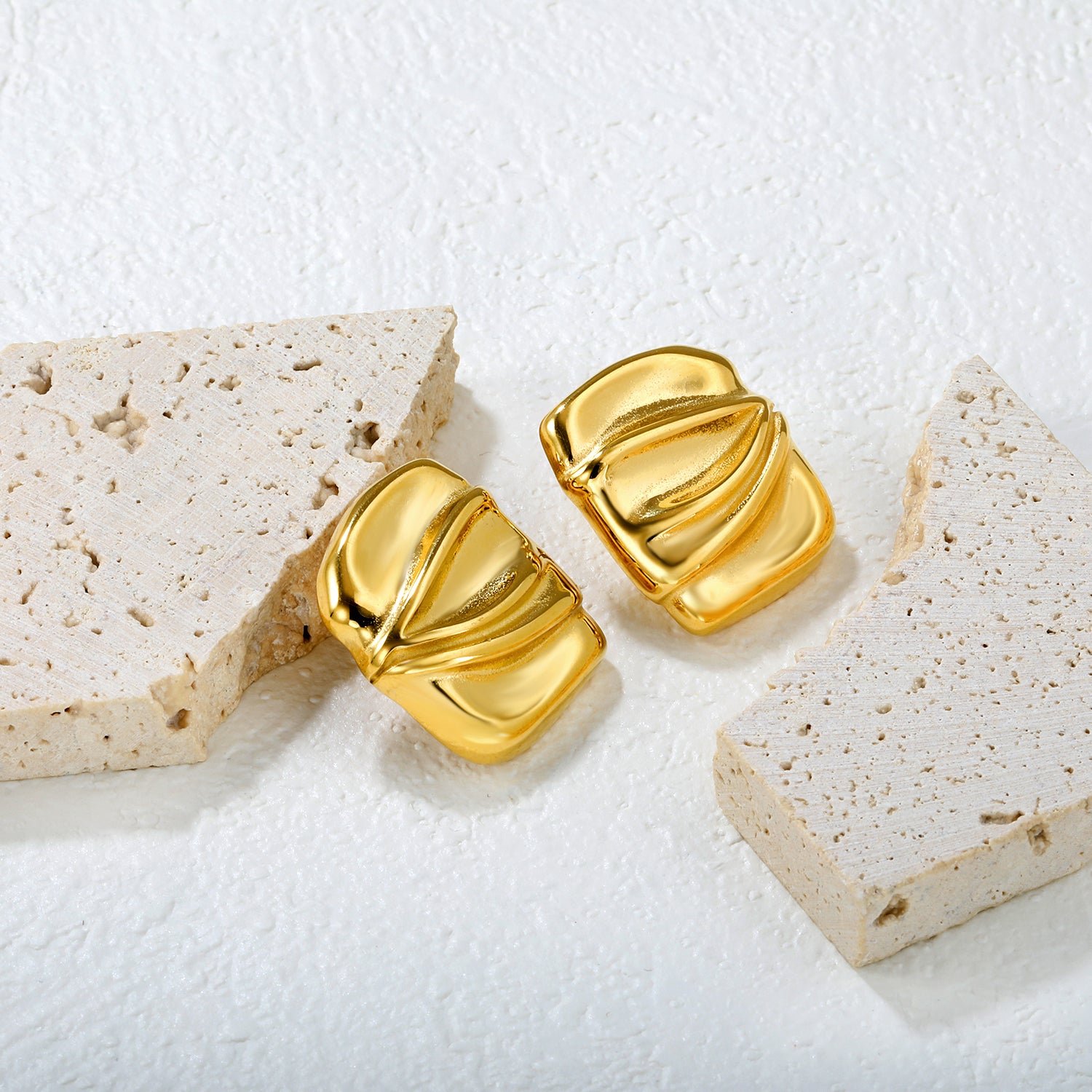 Wholesale 18K Gold Plated Crushed Metal Earrings Textured Surface Industrial ArtClose-up of the light-colored ambiance