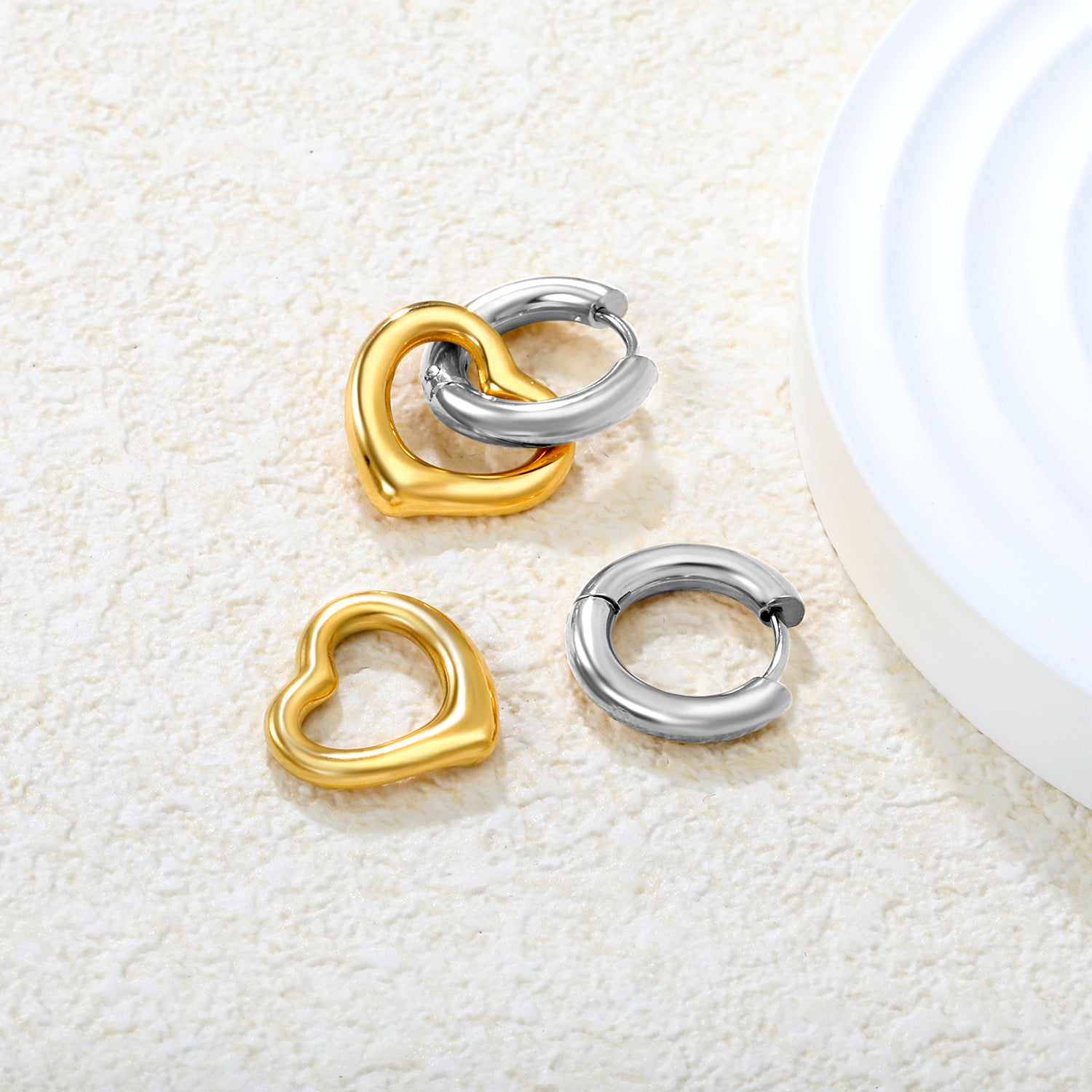 Wholesale 18K Gold Plated Heart Hoop Earrings Interlock Design Minimalist LuxuryClose-up of the light-colored ambiance