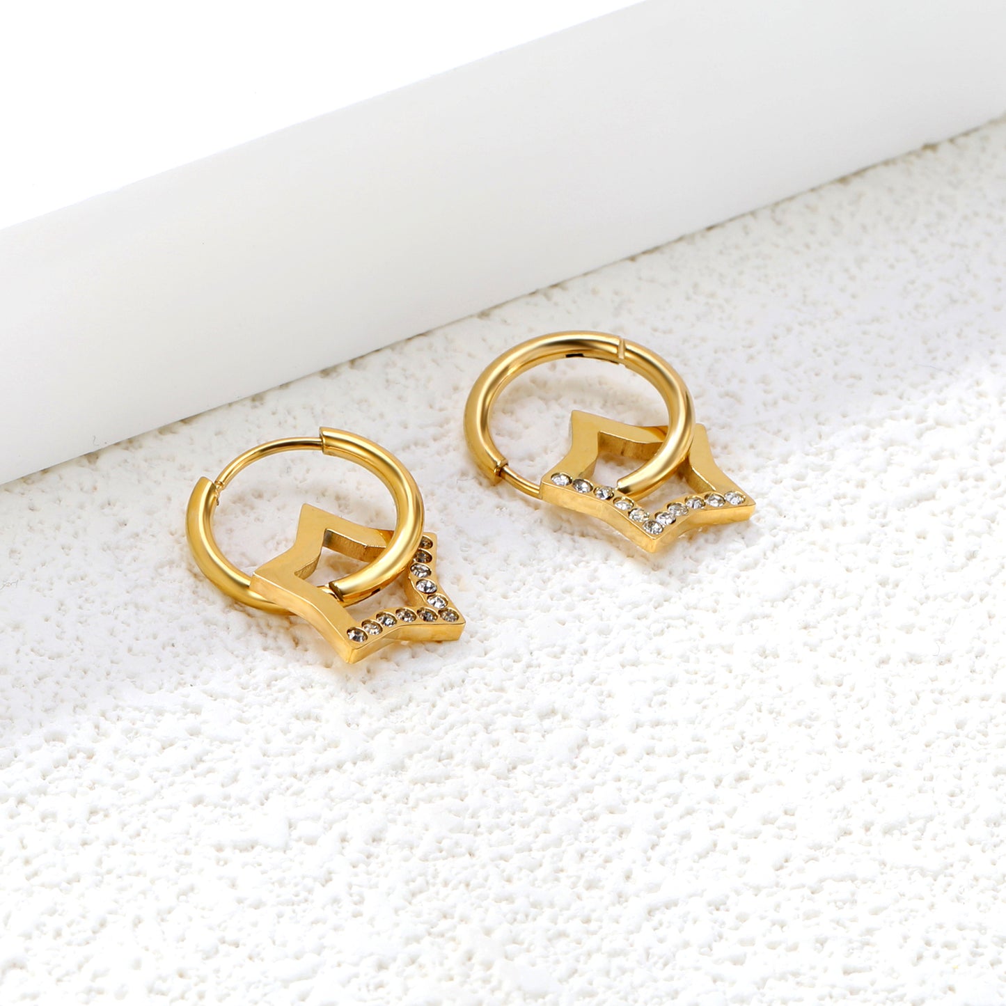 Wholesale 18K Gold Plated Star Drop Earrings Openwork Diamond Accent Celestial LuxuryClose-up of the light-colored ambiance