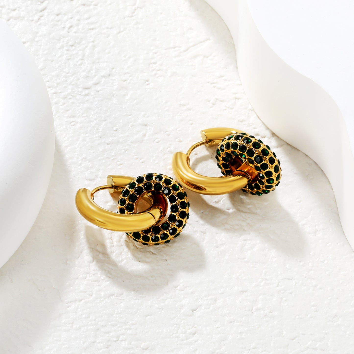 Wholesale Double Interlocking Hoop Earrings PVD Gold Crystal Tarnish FreeClose-up of the light-colored ambiance_green