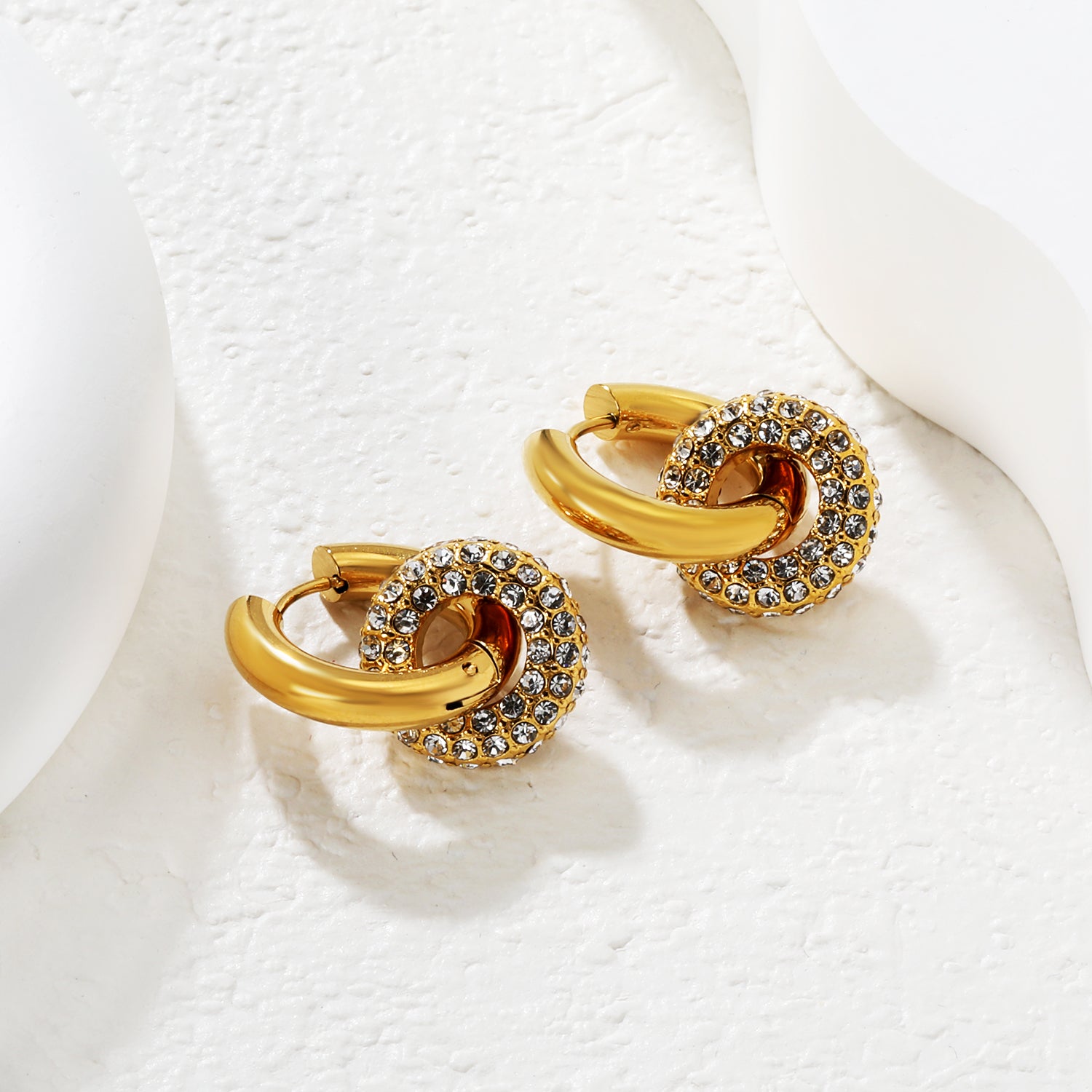 Wholesale Double Interlocking Hoop Earrings PVD Gold Crystal Tarnish FreeClose-up of the light-colored ambiance_white