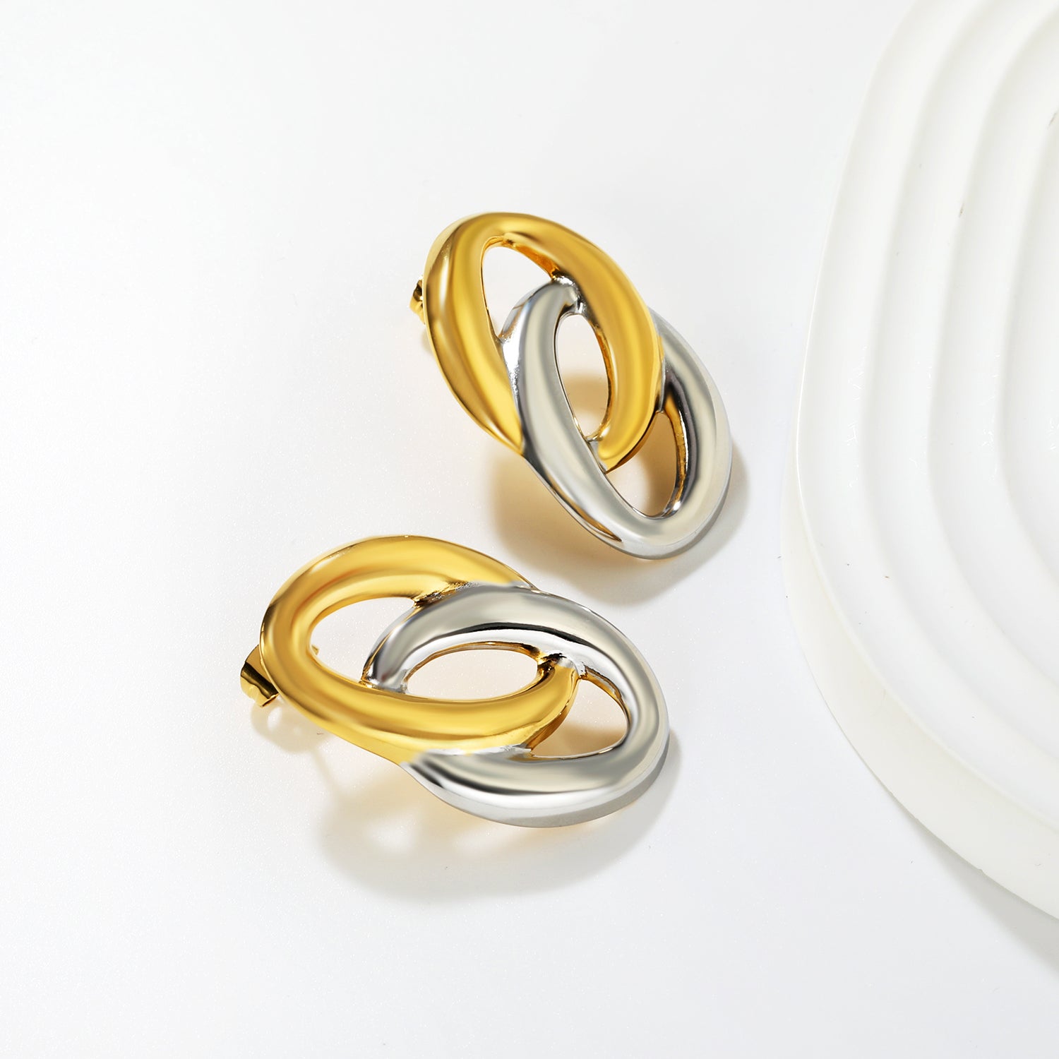 Wholesale Interlocking Hoop Earrings Two-Tone Gold & Silver - Jacey JewelryClose-up of the light-colored ambiance