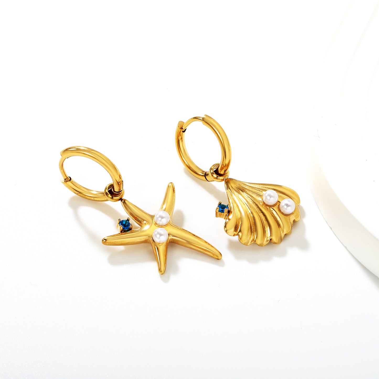 Wholesale Ocean Star Earrings 18K Gold Plated with Pearl & Zircon - Jacey JewelryClose-up of the light-colored ambiance