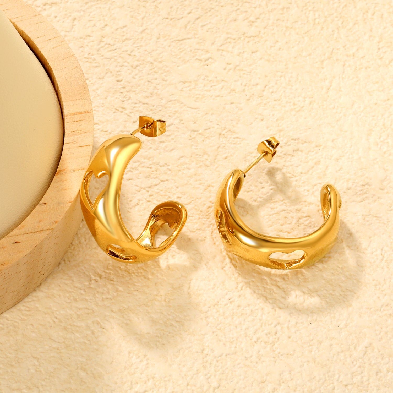 Wholesale Openwork C Hoop Earrings PVD Gold Geometric Design - Jacey JewelryClose-up of the light-colored ambiance
