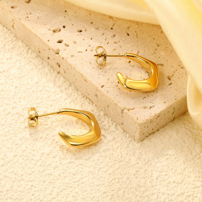 Wholesale Stainless Steel 18K Gold Plated Open Pentagon Stud EarringsClose-up of the light-colored ambiance