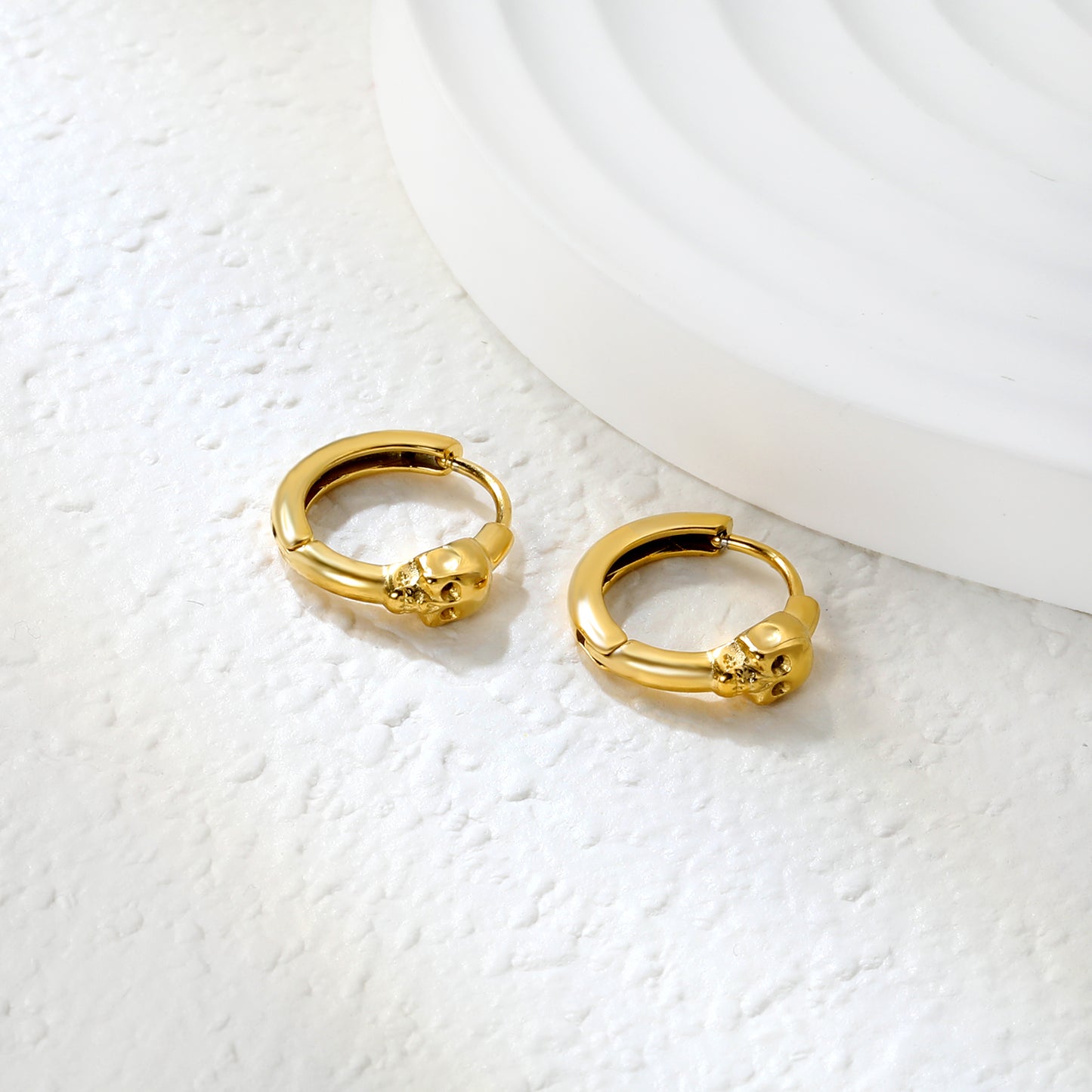Wholesale Stainless Steel 18K Gold Plated Skull Glossy Stud EarringsClose-up of the light-colored ambiance