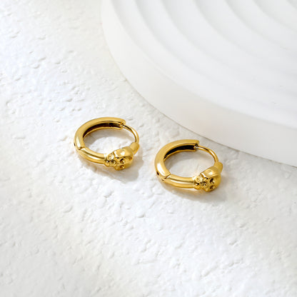 Wholesale Stainless Steel 18K Gold Plated Skull Glossy Stud EarringsClose-up of the light-colored ambiance