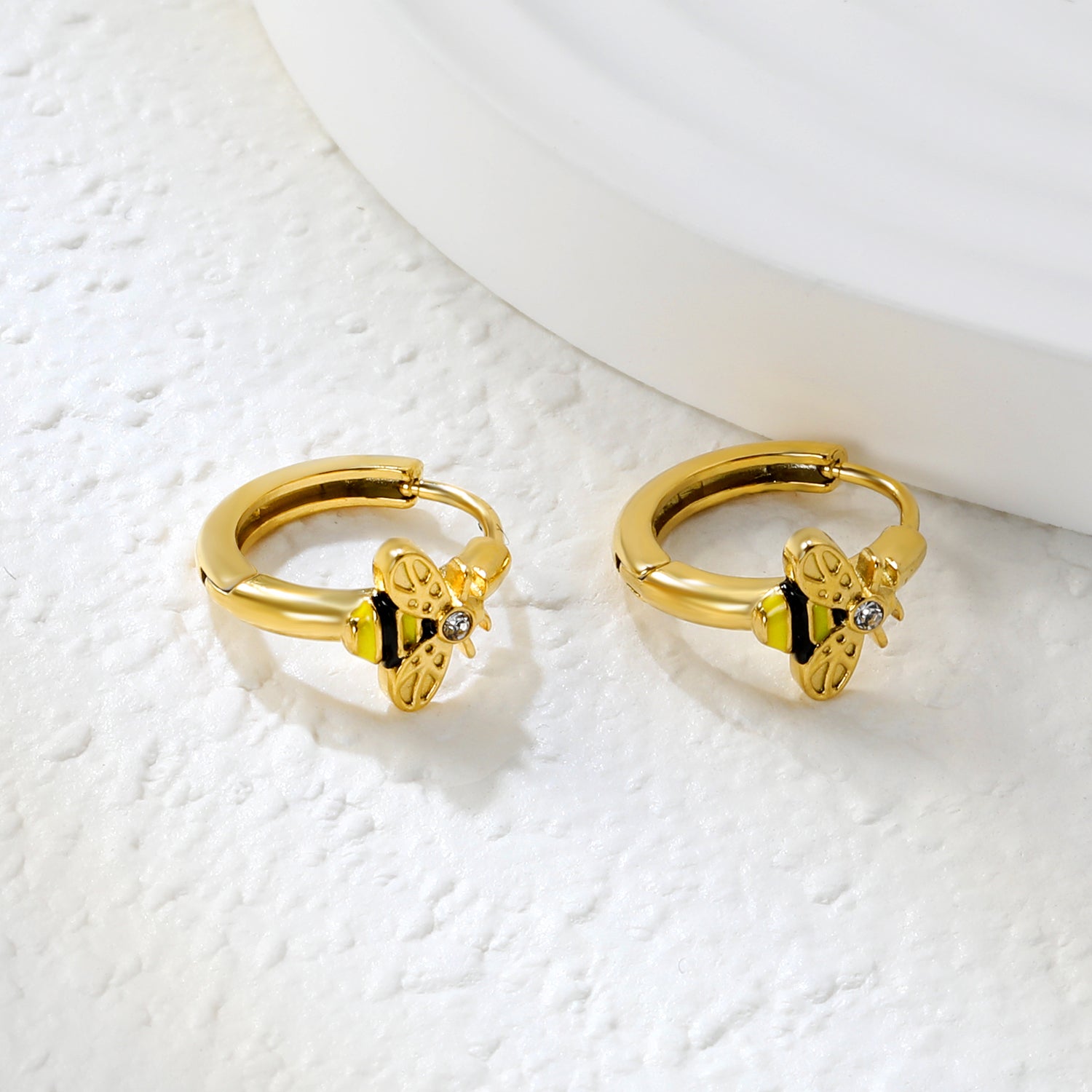 Wholesale Stainless Steel Botanical Bee CZ Hoop EarringsClose-up of the light-colored ambiance