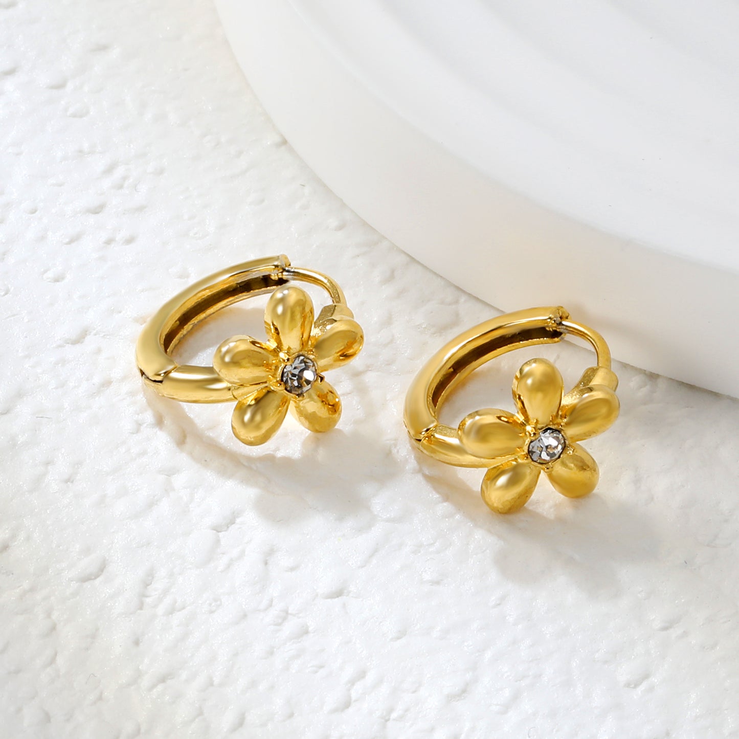 Wholesale Stainless Steel Botanical Flower Zircon Hoop EarringsClose-up of the light-colored ambiance