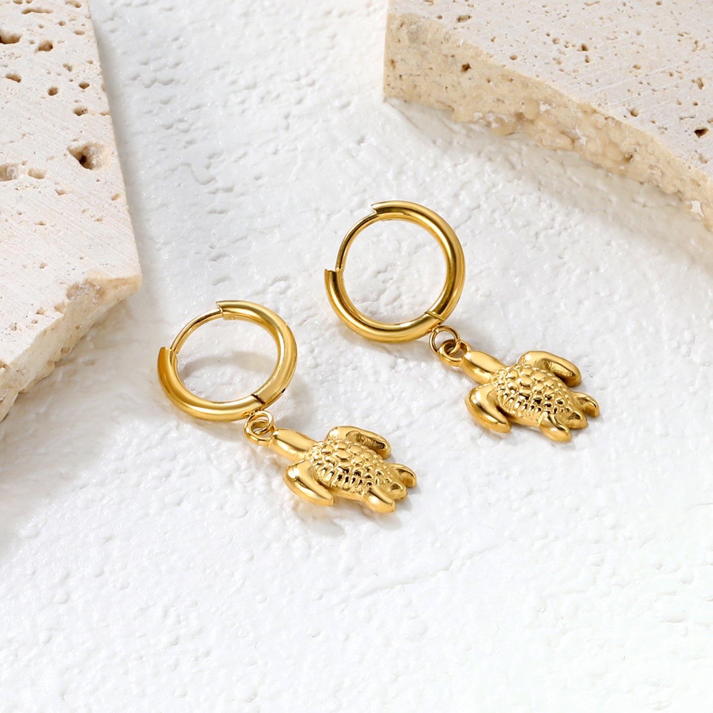 Wholesale Stainless Steel Botanical Turtle Charm Hoop EarringsClose-up of the light-colored ambiance