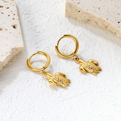 Wholesale Stainless Steel Botanical Turtle Charm Hoop EarringsClose-up of the light-colored ambiance