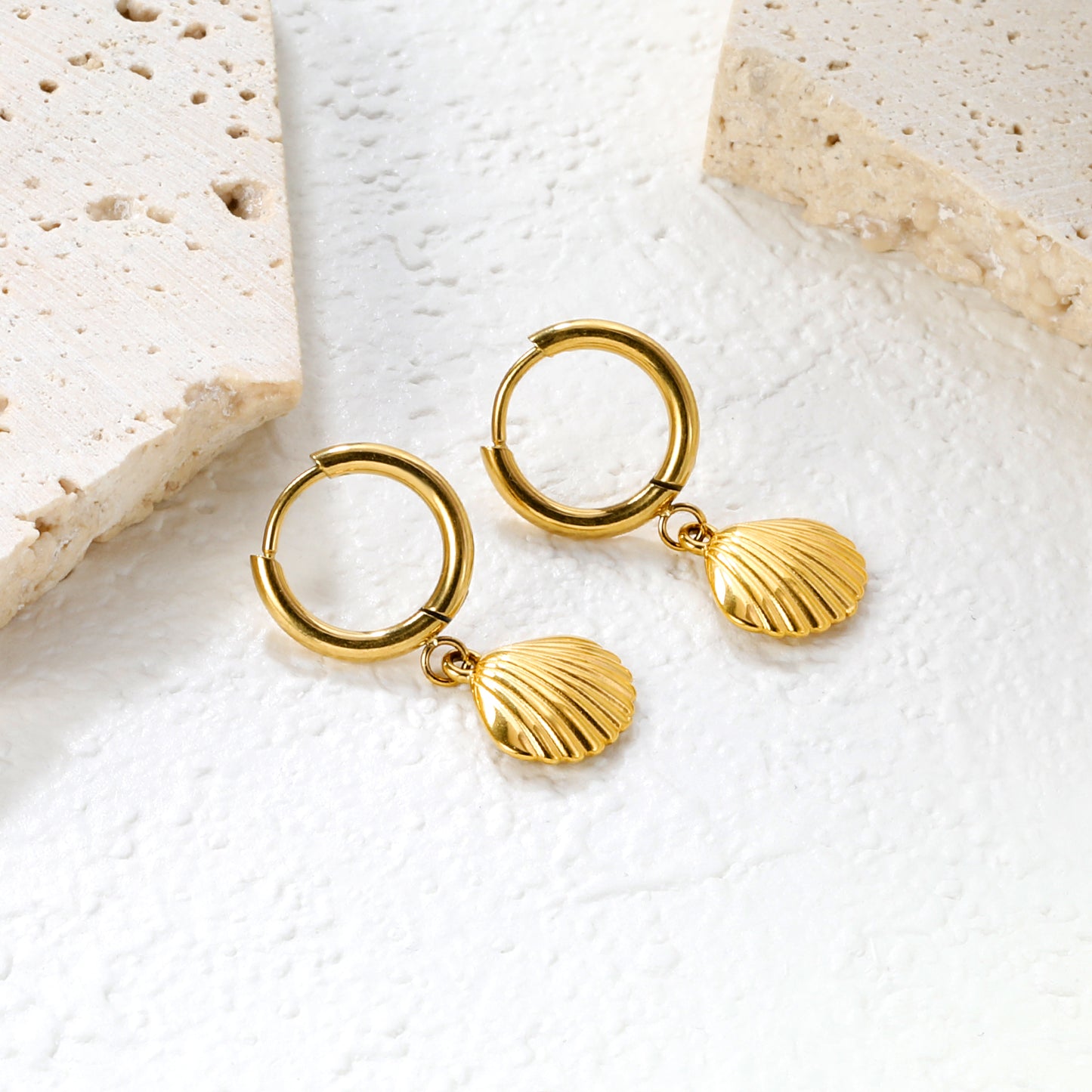 Wholesale Stainless Steel Coastal Shell Charm Hoop EarringsClose-up of the light-colored ambiance
