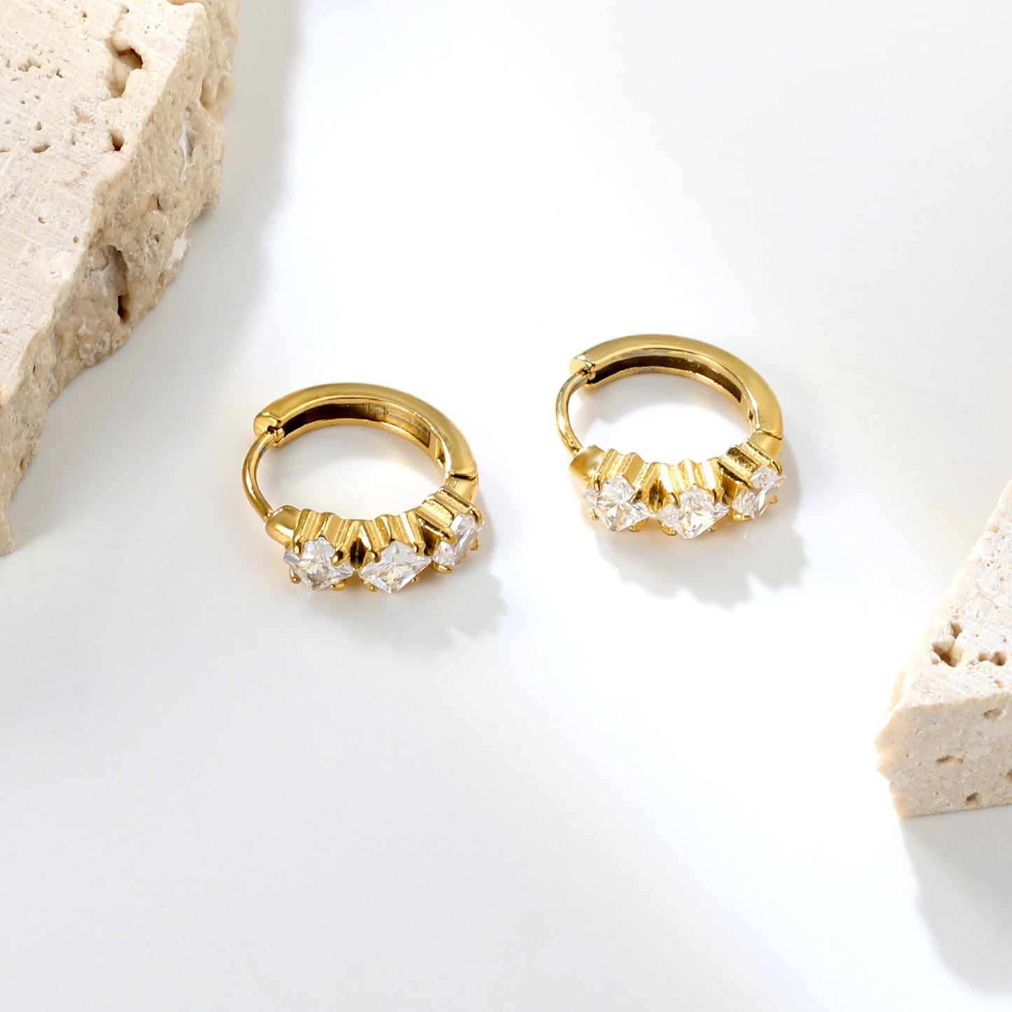 Wholesale Stainless Steel Contemporary Triple Square Zircon Hoop EarringsClose-up of the light-colored ambiance