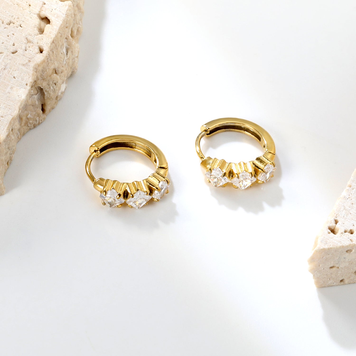 Wholesale Stainless Steel Contemporary Triple Square Zircon Hoop EarringsClose-up of the light-colored ambiance