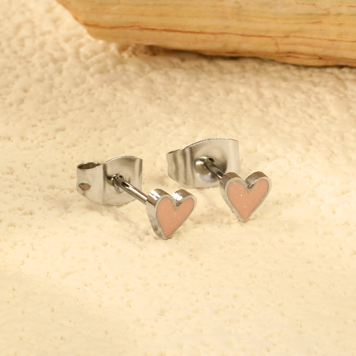 Wholesale Stainless Steel Heart with Pink Glitter Drip EarringsClose-up of the light-colored ambiance