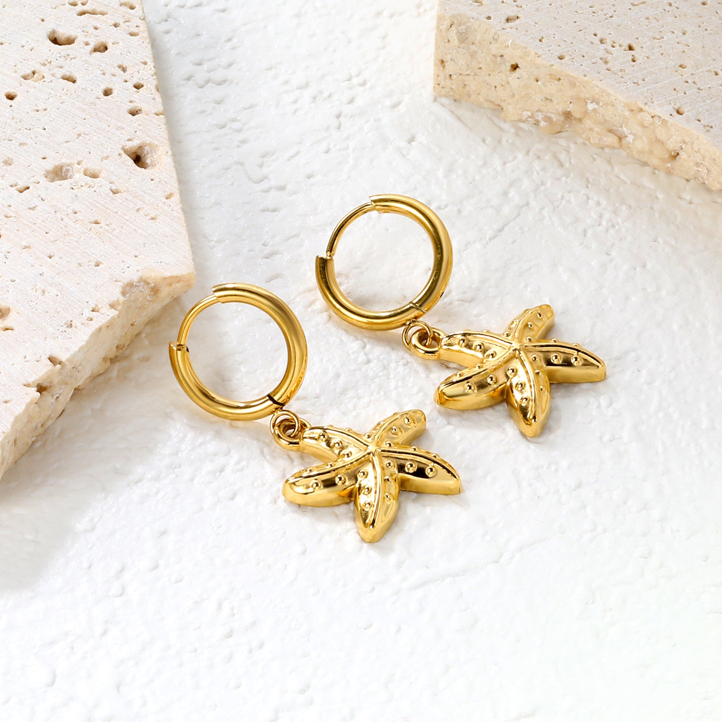 Wholesale Stainless Steel Luxe Large Starfish Charm Hoop EarringsClose-up of the light-colored ambiance