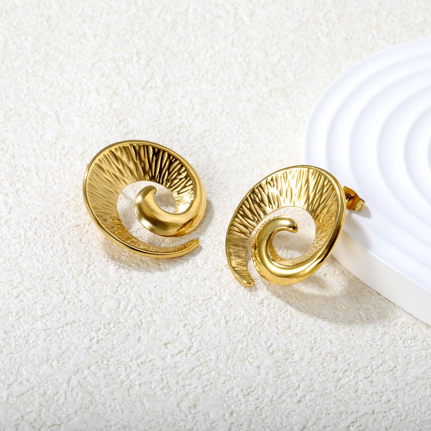 Wholesale Stainless Steel Luxe Spiral Ram Horn Stud EarringsClose-up of the light-colored ambiance
