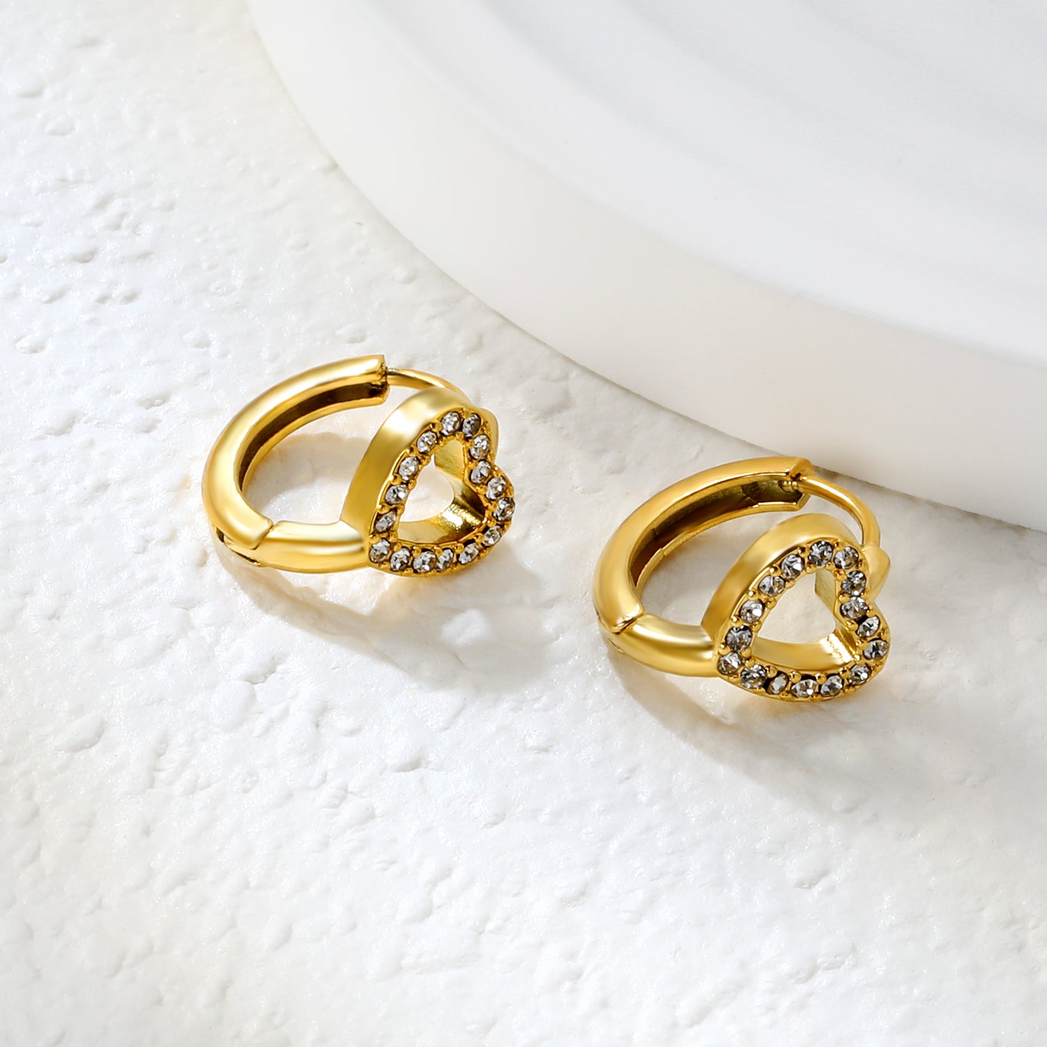 Wholesale Stainless Steel Romantic Hollow Heart Zircon Hoop EarringsClose-up of the light-colored ambiance