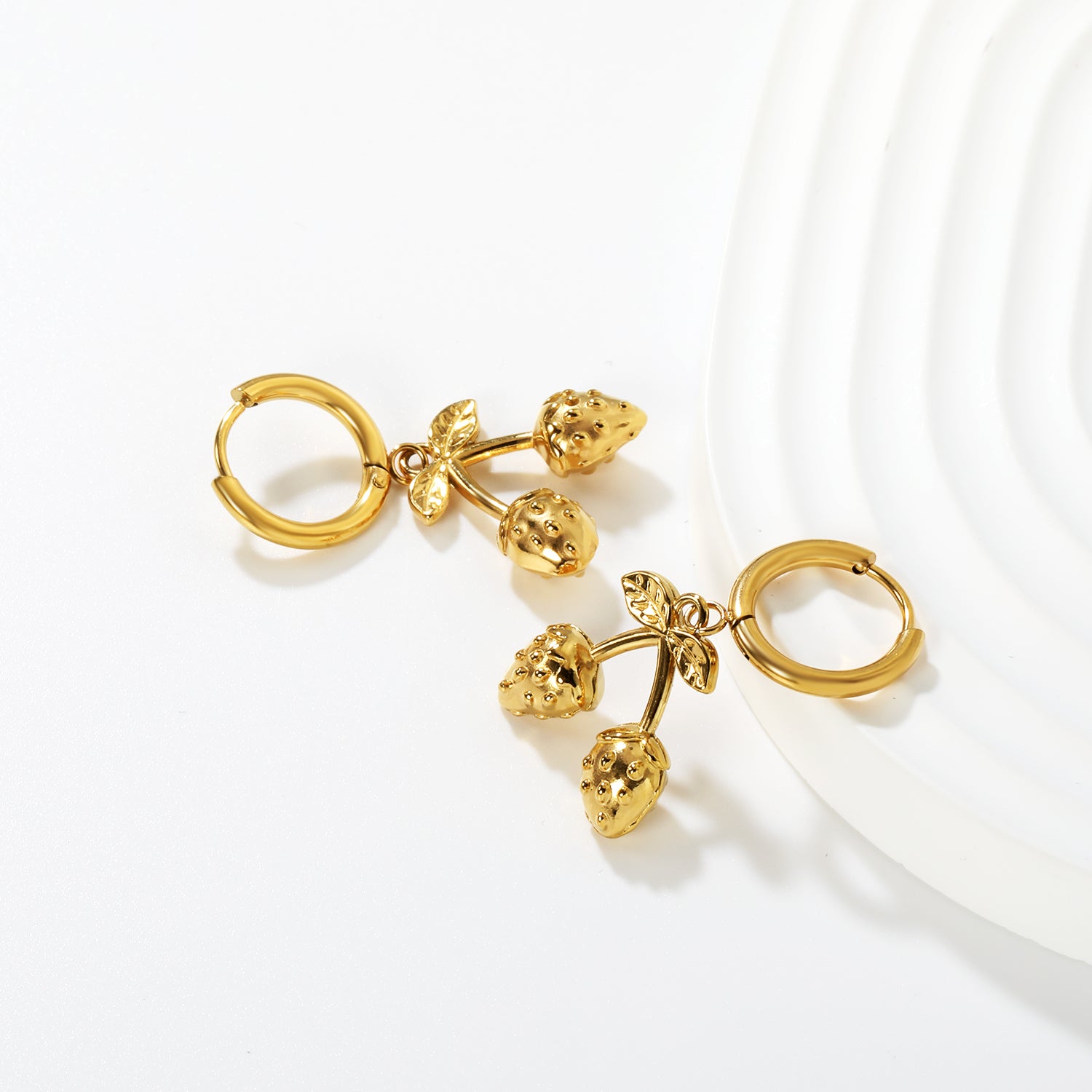 Wholesale Strawberry Earrings 18K Gold Plated Cute Dangle - Jacey JewelryClose-up of the light-colored ambiance