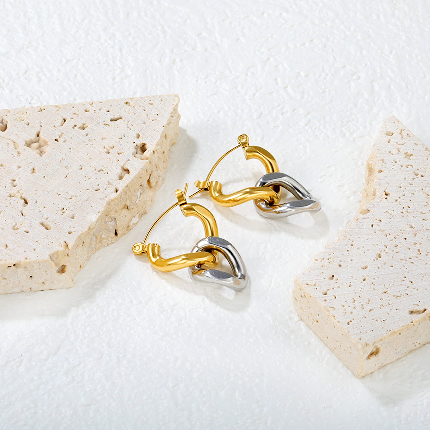 Wholesale Two-Tone Hoop Earrings Gold and Silver Interwoven Design Light LuxuryClose-up of the light-colored ambiance