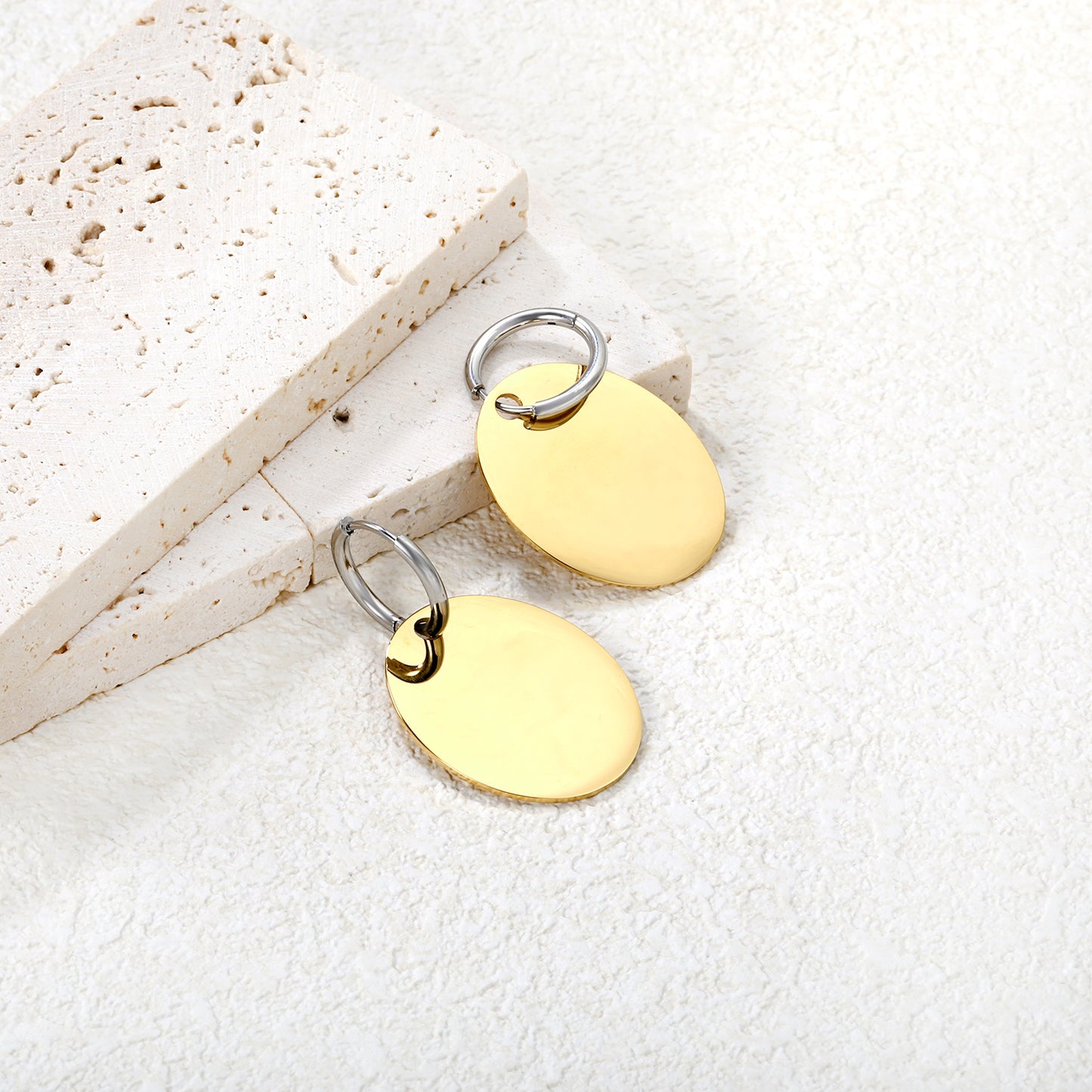 Wholesale Two-Tone Hoop with Gold Disc Earrings Contrast Design Minimalist LuxuryClose-up of the light-colored ambiance