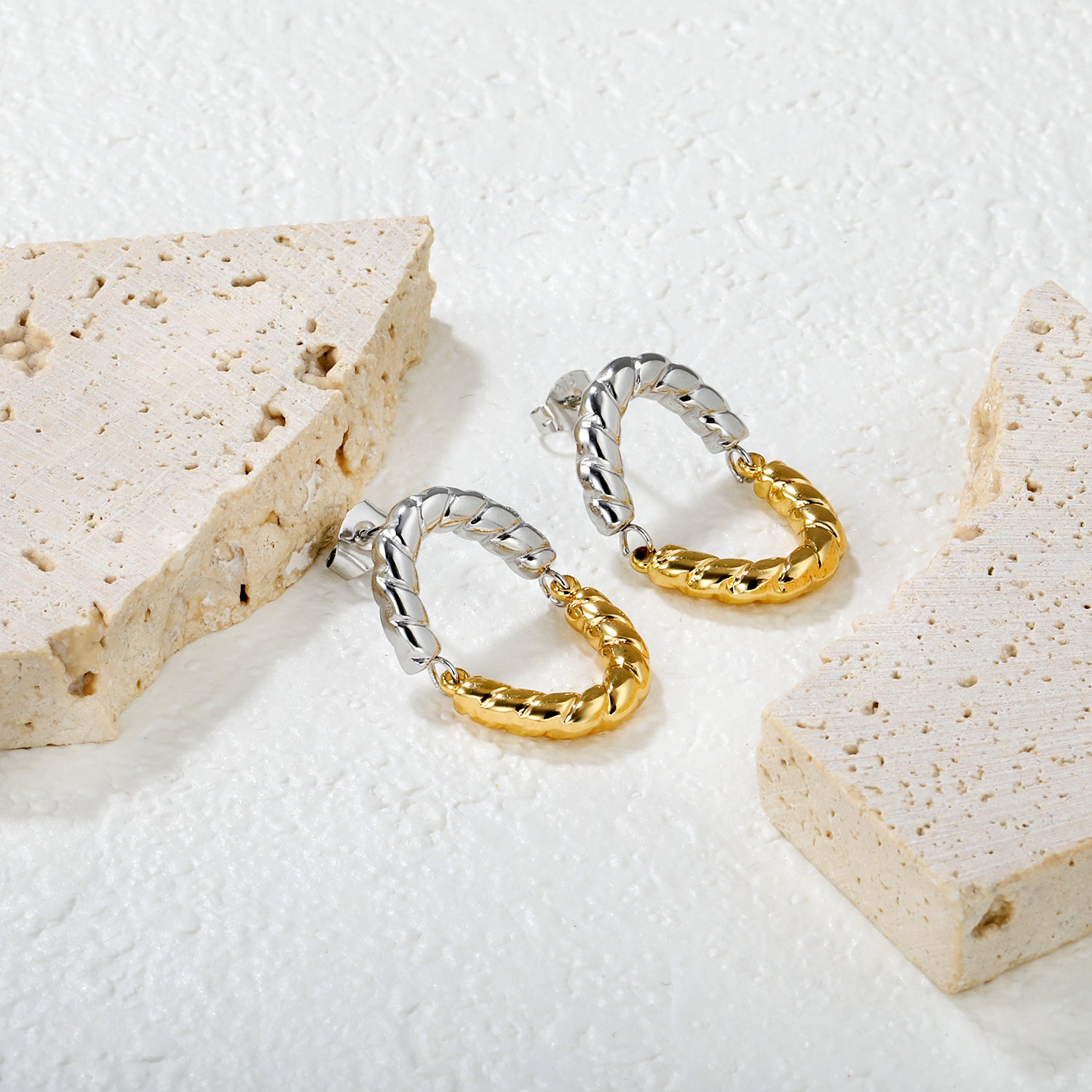 Wholesale Two-Tone Woven Hoop Earrings Gold and Silver Braid Industrial LuxuryClose-up of the light-colored ambiance
