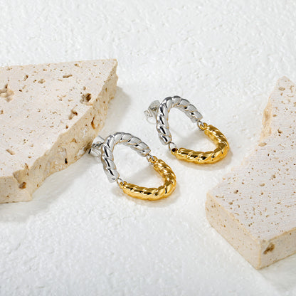 Wholesale Two-Tone Woven Hoop Earrings Gold and Silver Braid Industrial LuxuryClose-up of the light-colored ambiance