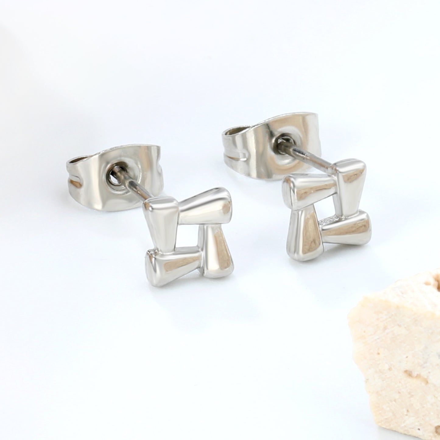 Wholesale stainless steel 18K gold plated openwork quadrilateral plain pin earringsClose-up of the light-colored ambiance_silver