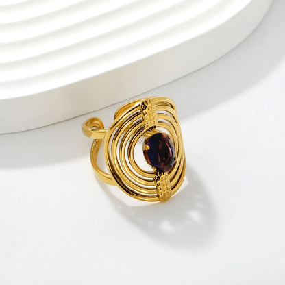 Striking Contrast Between Rough Textured Gold and Smooth Faceted Gemstone