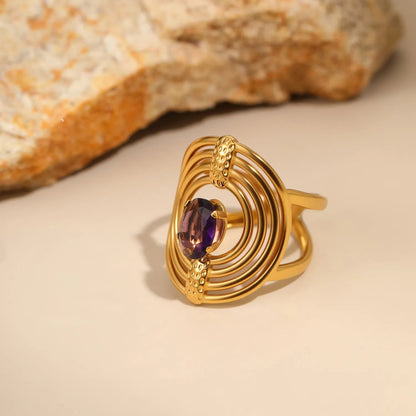 Striking Contrast Between Rough Textured Gold and Smooth Faceted Gemstone